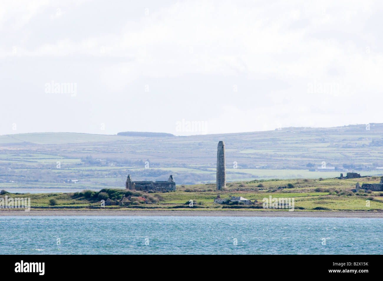 A zoom shot of Scattery Island and its round tower, in the Shannon Estuary in County Clare Ireland Stock Photo