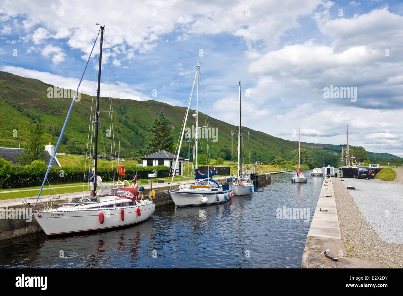 Sailing and motor boats in the process of entering the Loch Lochy Laggan locks on the Caledonian Canal in the Scottish Highlands Stock Photo