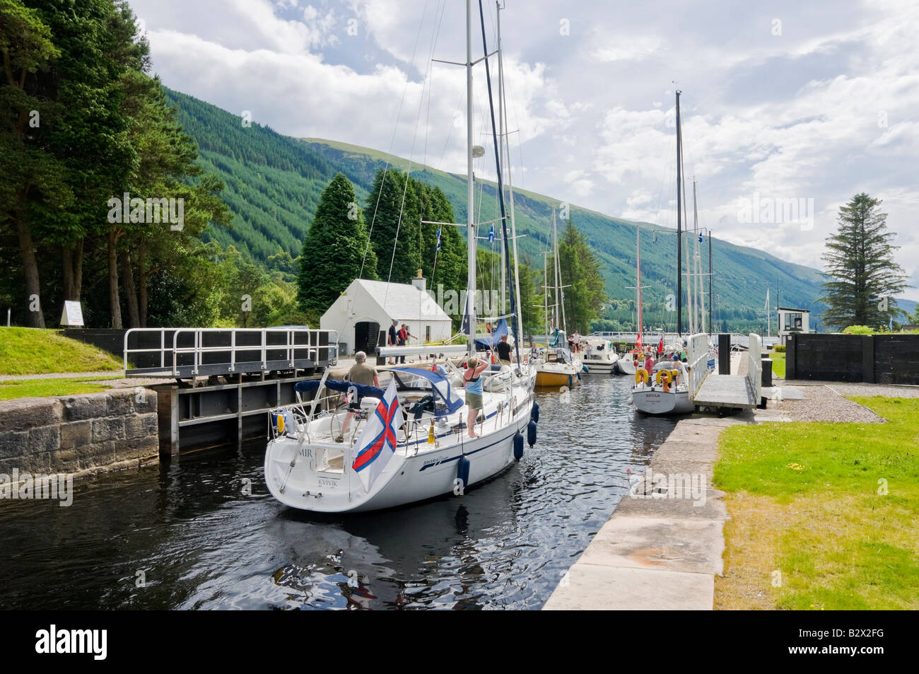 Sailing and motor boats in the process of mooring in the Loch Lochy Laggan locks on the Caledonian Canal in Scotland Stock Photo