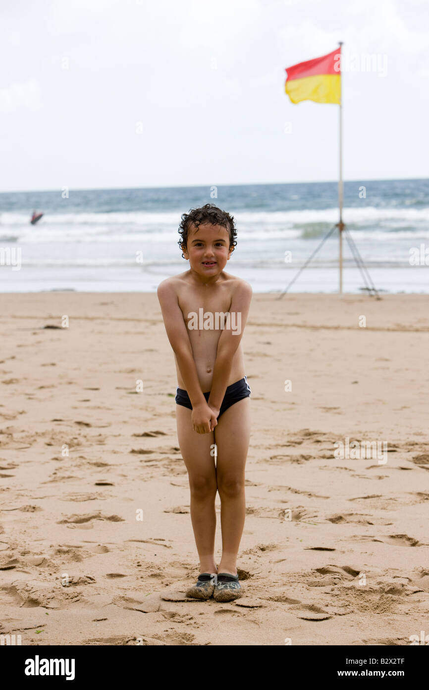 Little boy shivering after a swim in the freezing cold sea Stock Photo