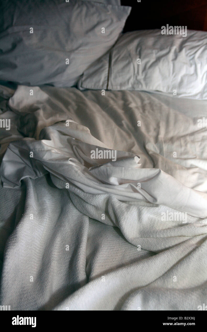 Rumpled clean white linen bed Stock Photo Alamy