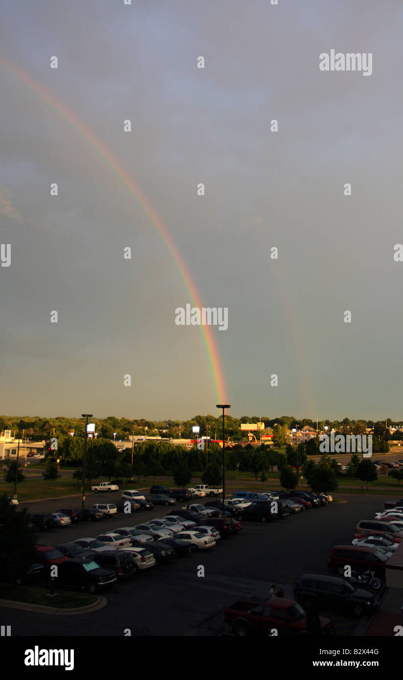 A rainbow with a faint double after a squall line thunderstorm. Stock Photo
