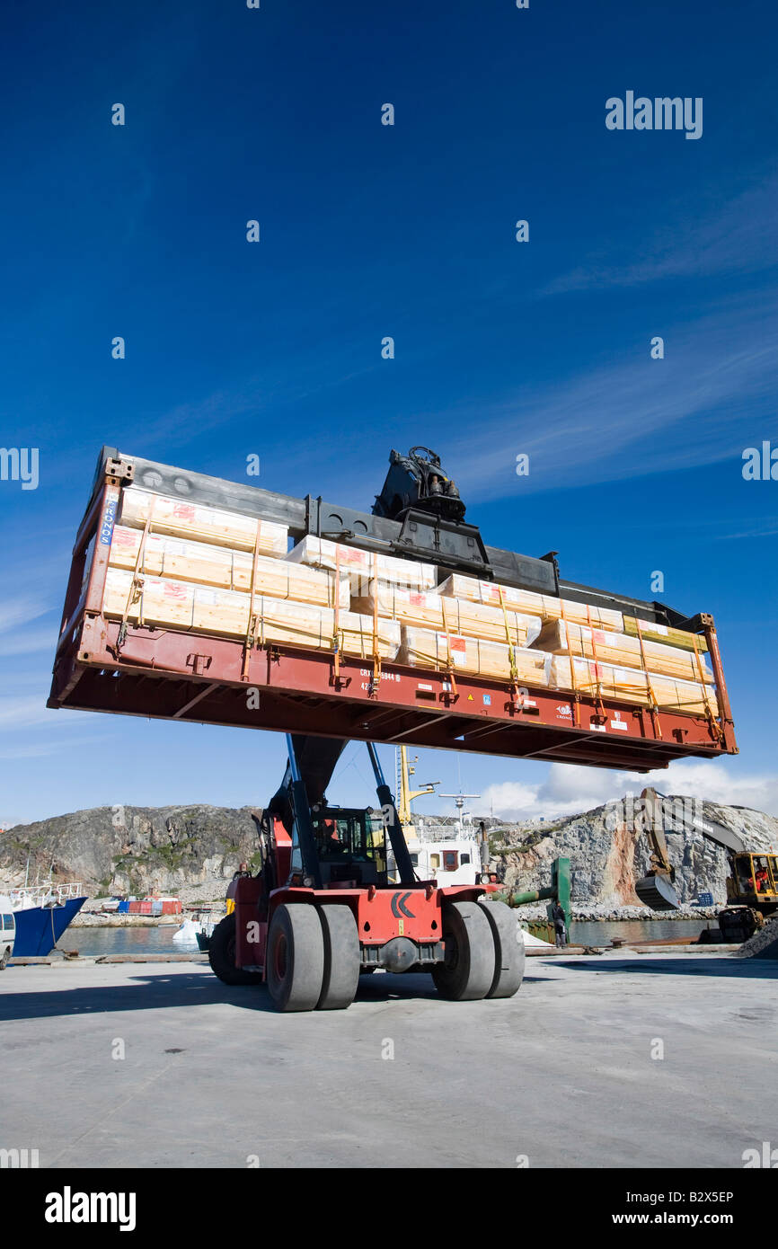 Moving freight containers around at Ilulissat dock on Greenland Stock Photo