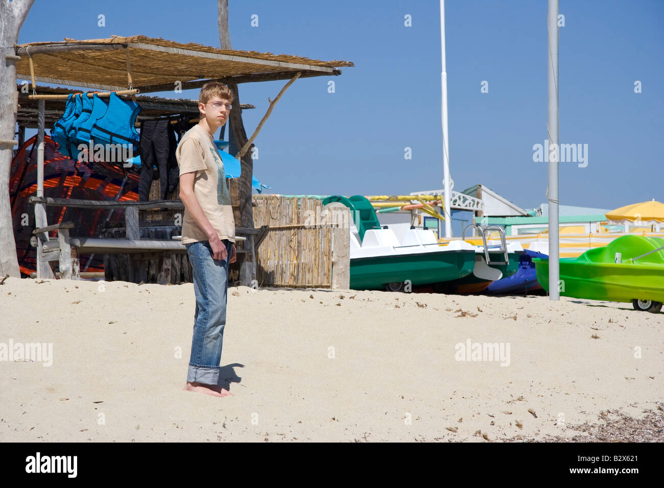 teenager in front of a boat hire - beach of saint tropez, french riviera Stock Photo