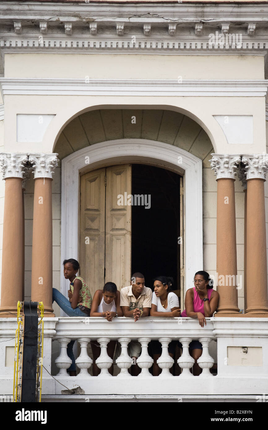 People watch from a balcony as a parade goes by during the Fire festival in Santiago Cuba on Friday August 8 2008 Stock Photo