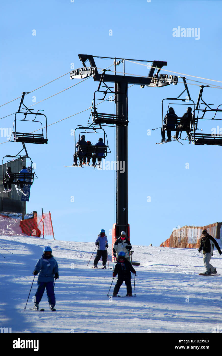Chairlift with skiers on downhill ski resort Stock Photo Alamy