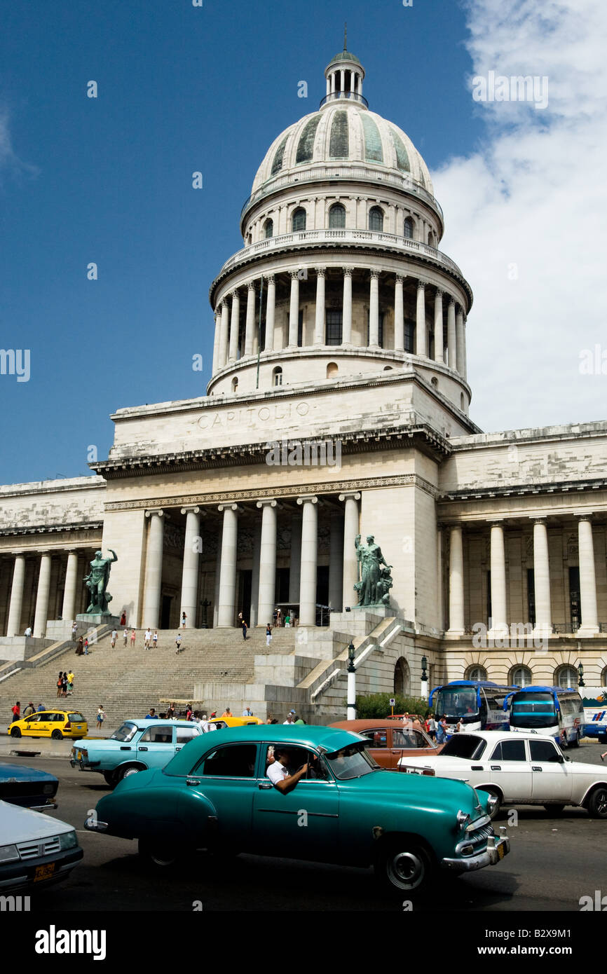 A vintage American car drives by the national capitol building in central Havana, Cuba Stock Photo