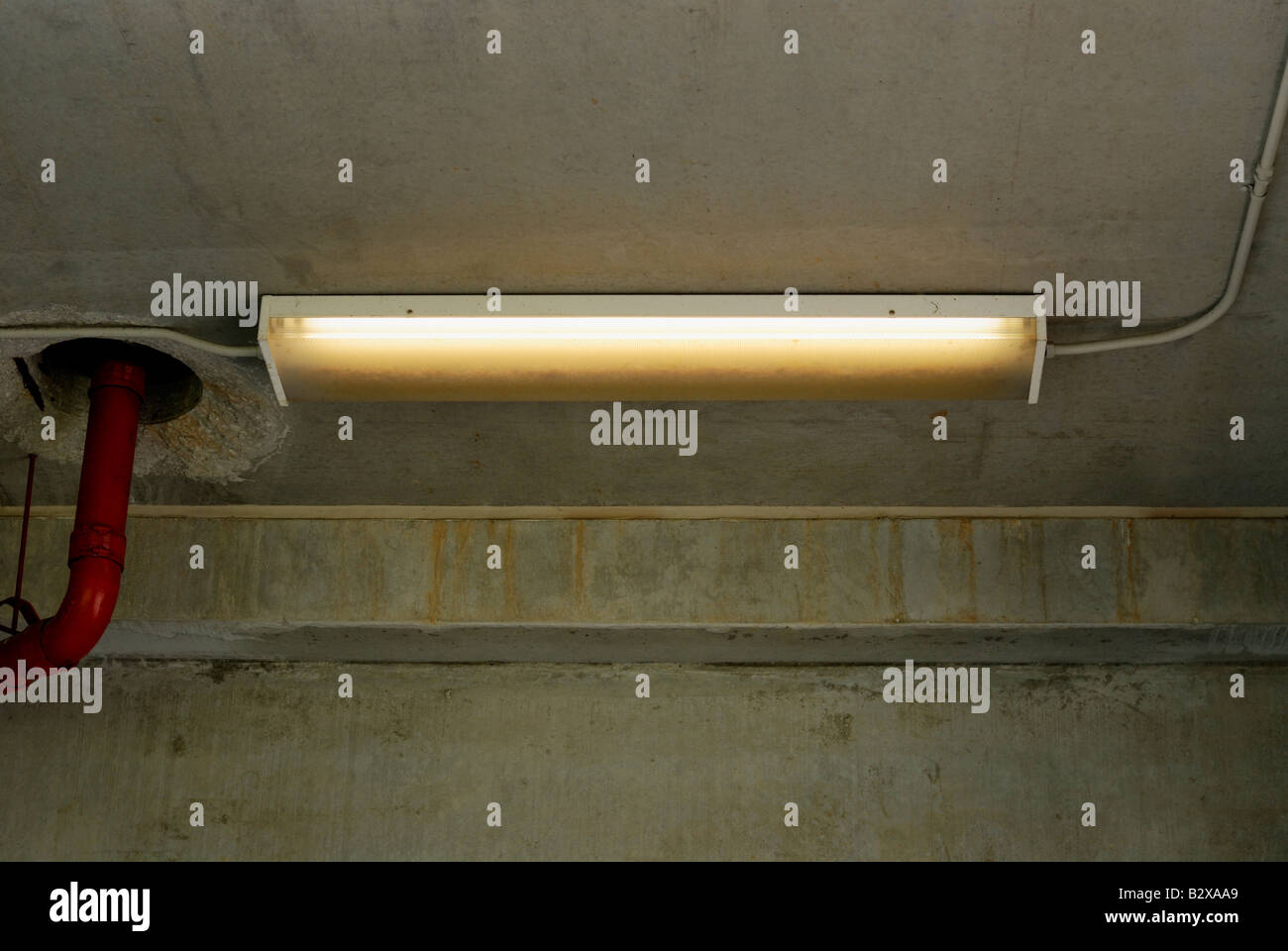 Flourescent light fixture with one bulb burnt out Stock Photo Alamy