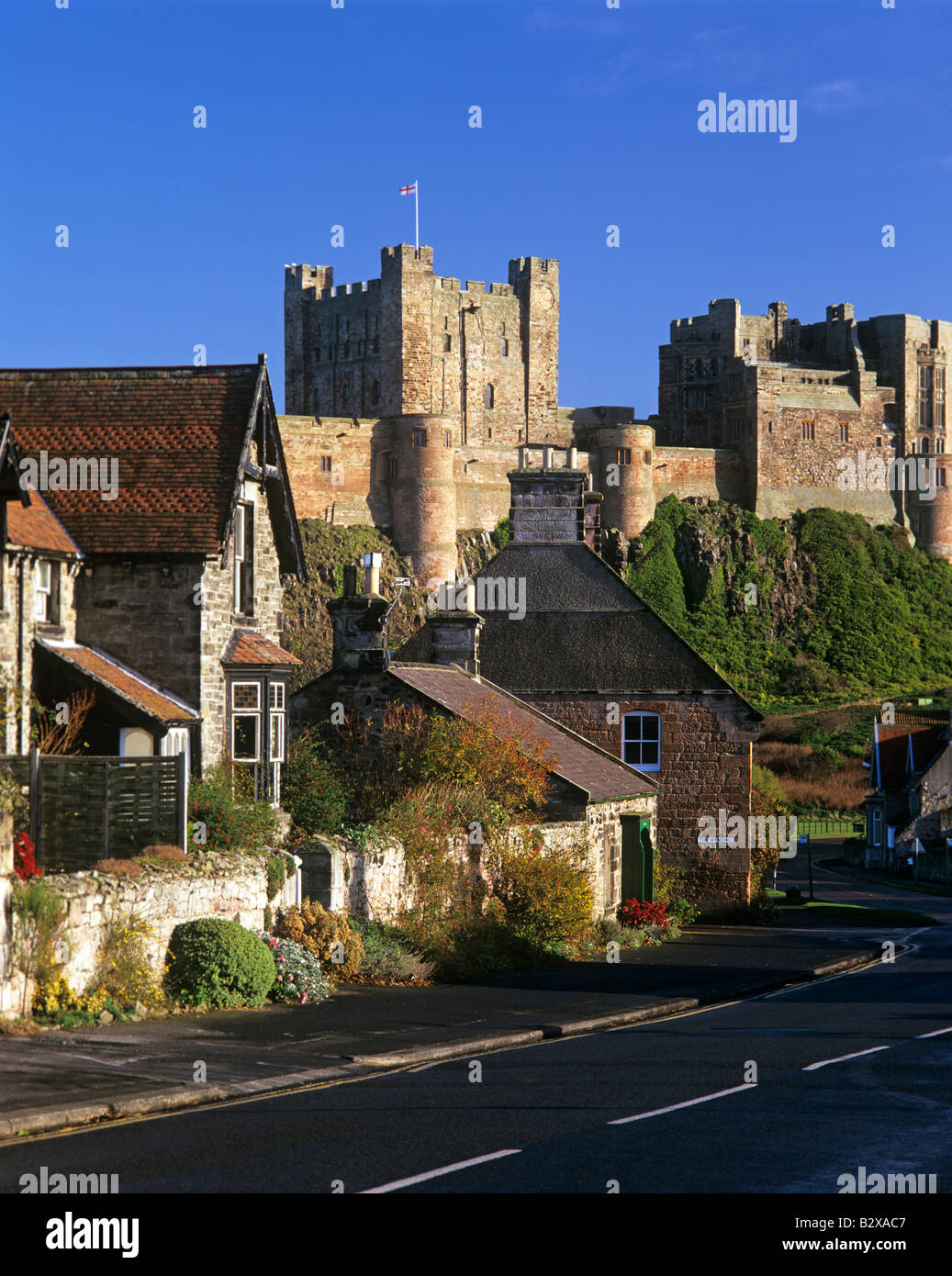 The village of Bamburgh on Northumberland coast in England is dominated ...