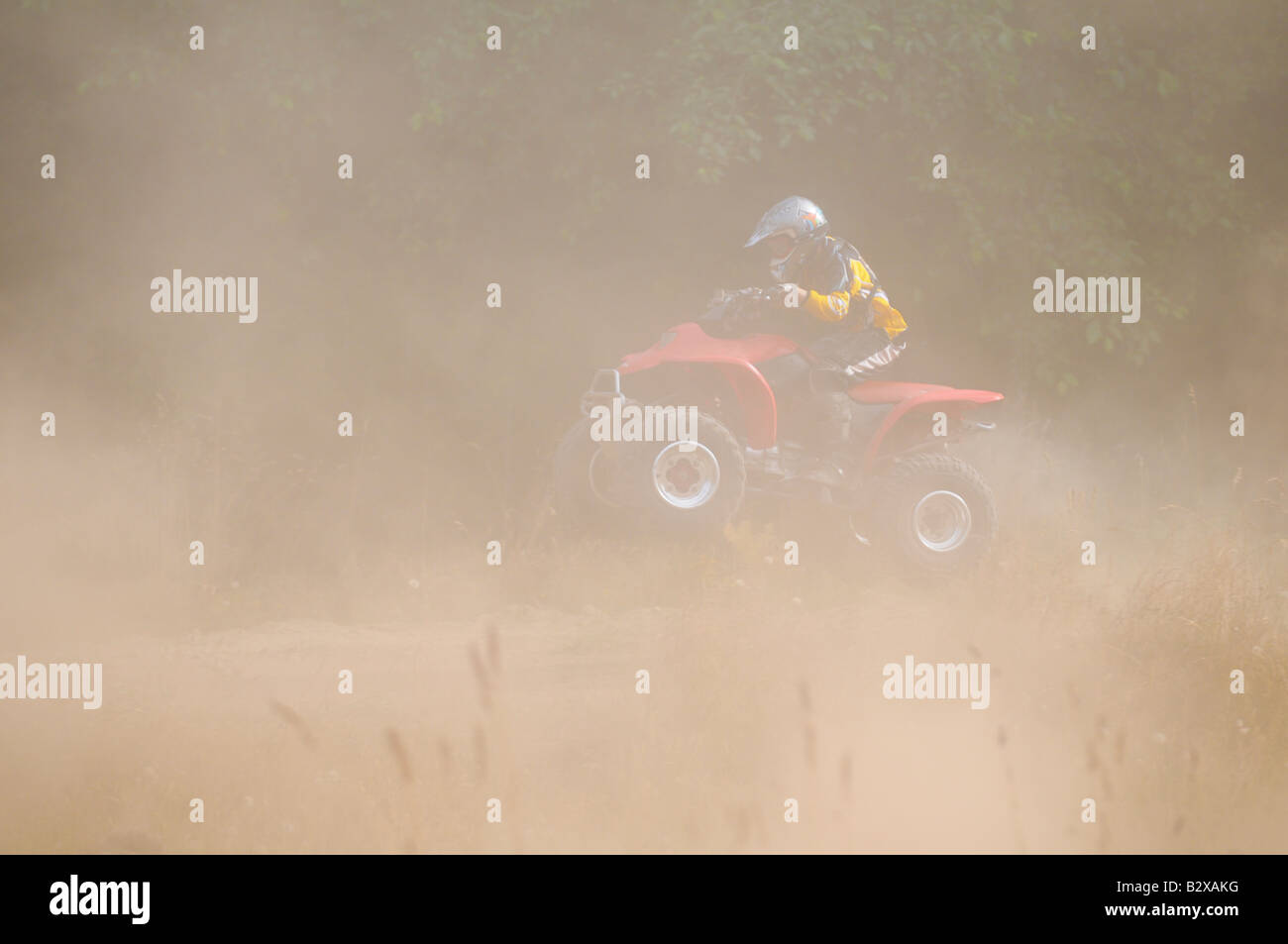 ATV captured in mid-air through clouds of dust Stock Photo
