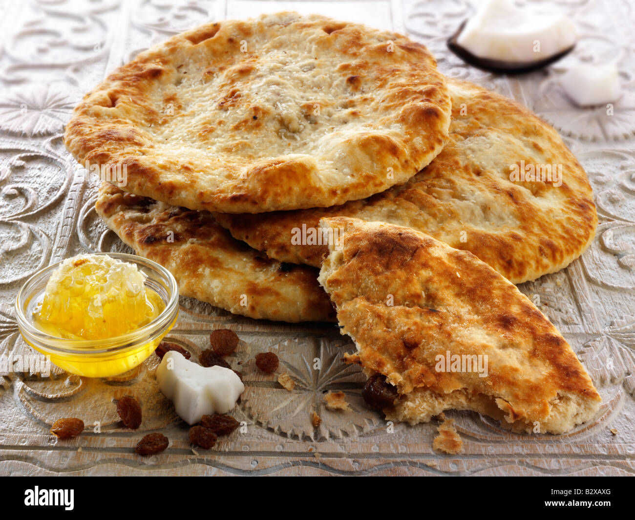 Peshwari Naan. coconut sultanas and honey Bread served ready to eat on a table - Indian Cuisine Stock Photo