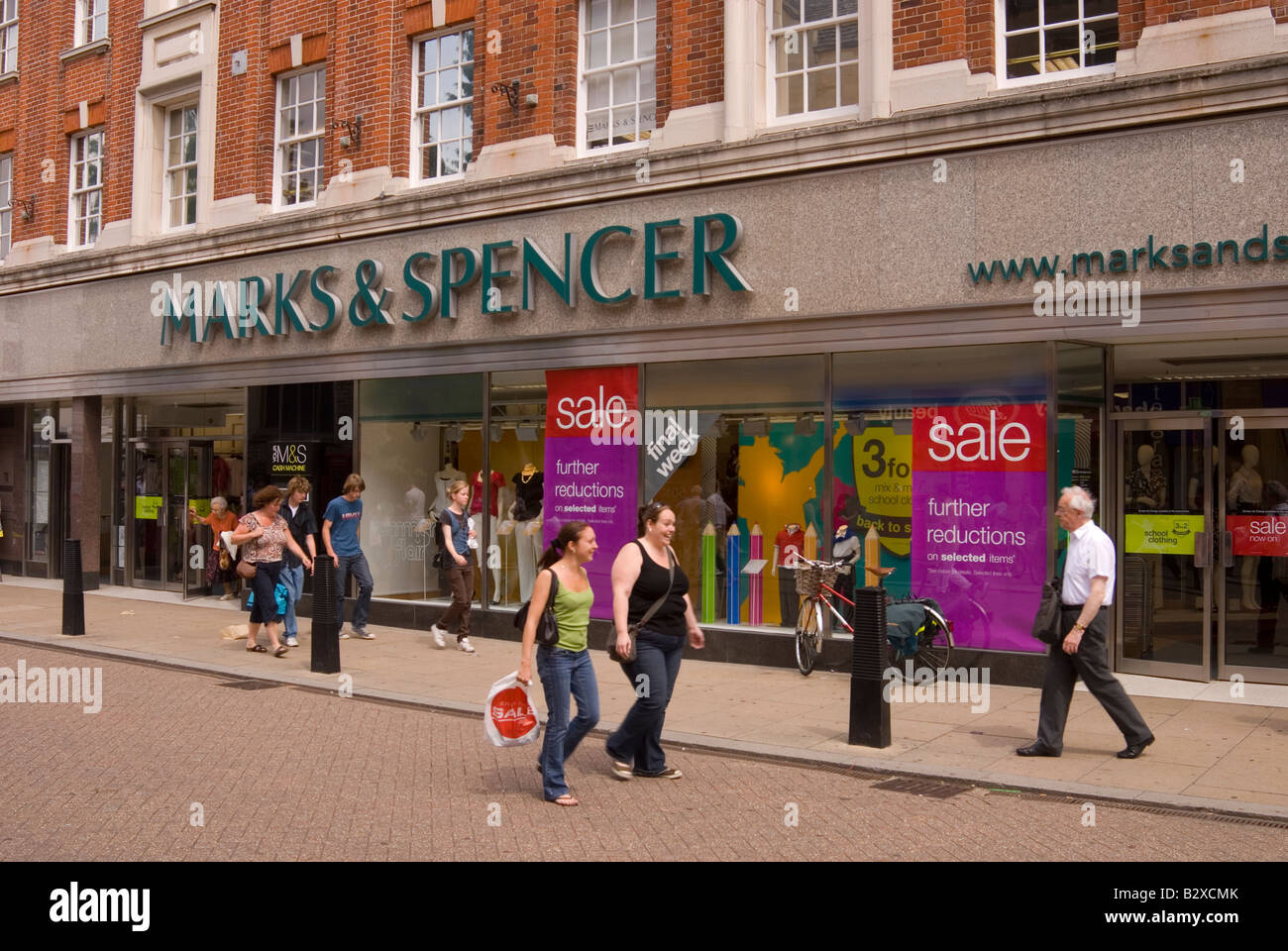 Marks & Spencers sale with people walking by in the uk Stock Photo Alamy