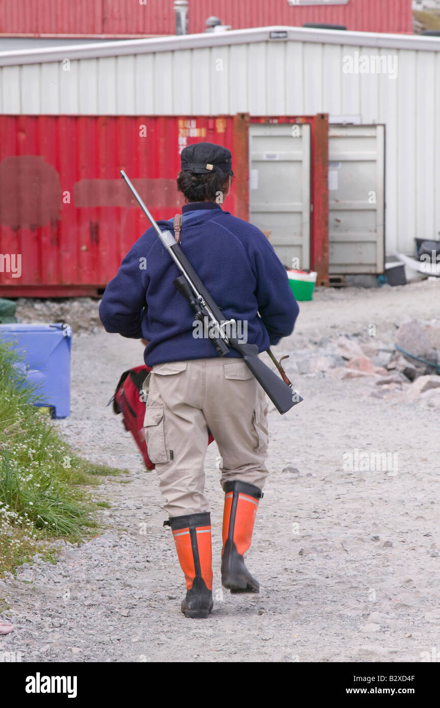 An Inuit hunter on the quayside at Ilulissat in Greenland Stock Photo