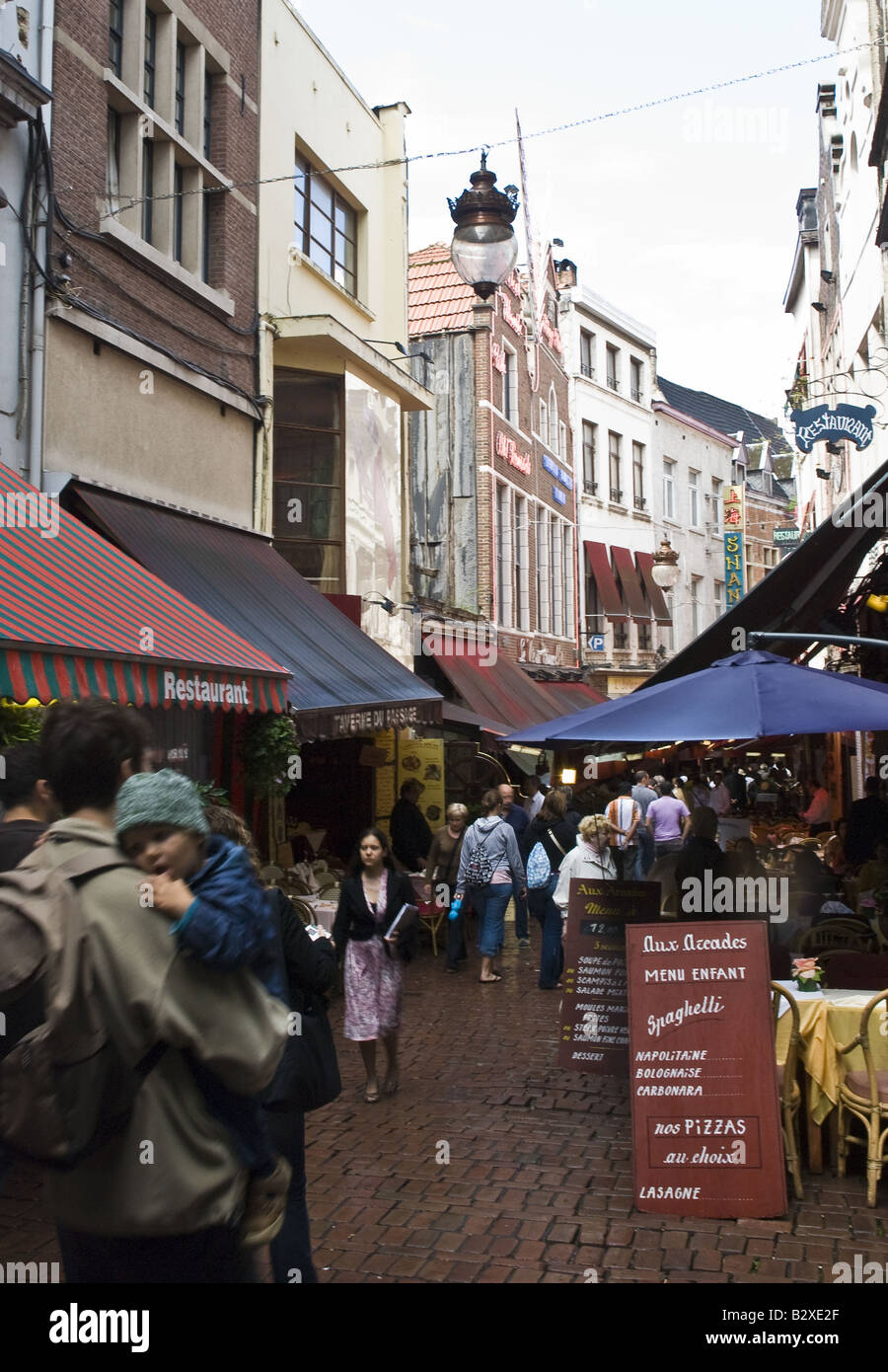 Busy Rue de Borches with many restaurants selling mussels and beer, in Brussels, Belgium. Stock Photo