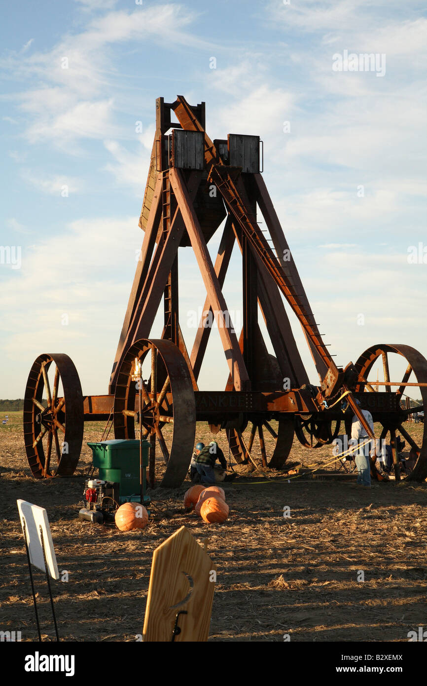 Huge iron wheeled Yankee Siege Trebuchet with fling arm wound all the way down to ground Stock Photo