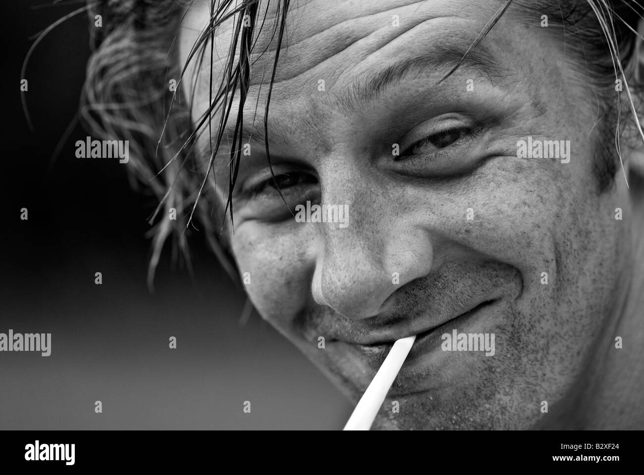 Scruffy man smoking a cigarette Stock Photo