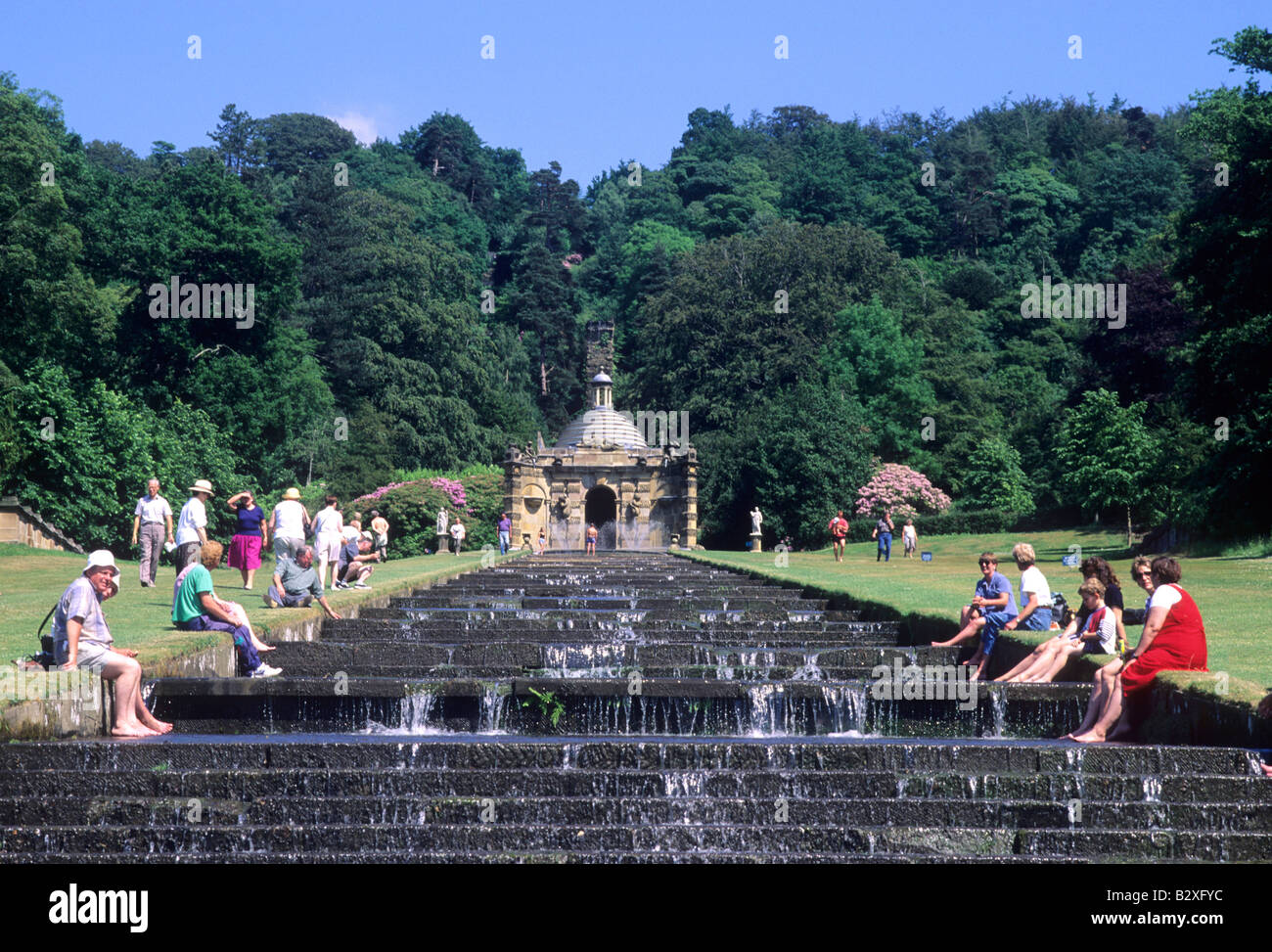 Visitors people enjoying The Cascade Chatsworth landscaped garden waterfall temple water tourists tourism Derbyshire England UK Stock Photo