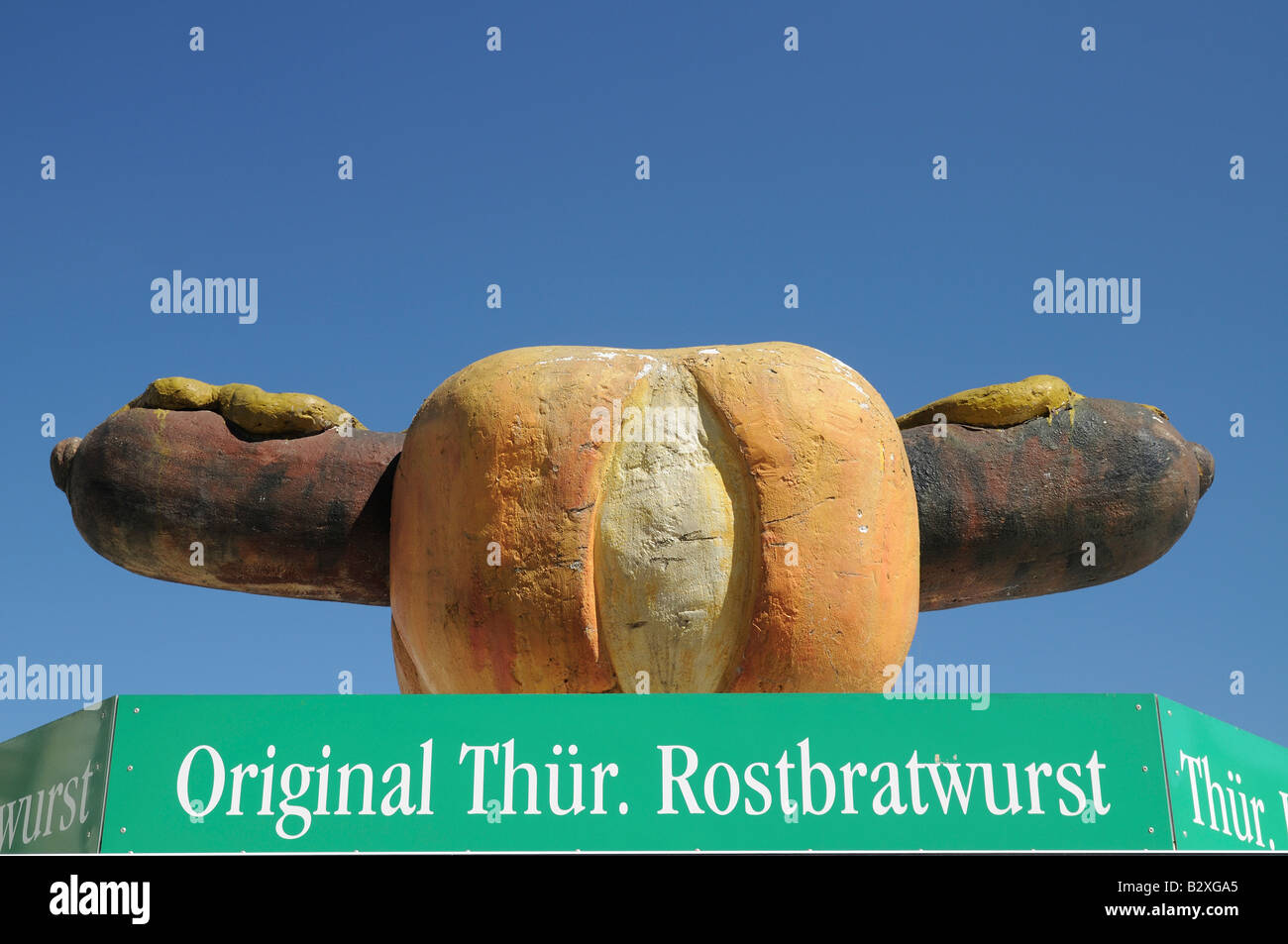 Model of giant German sausage on top of sausage stand selling original