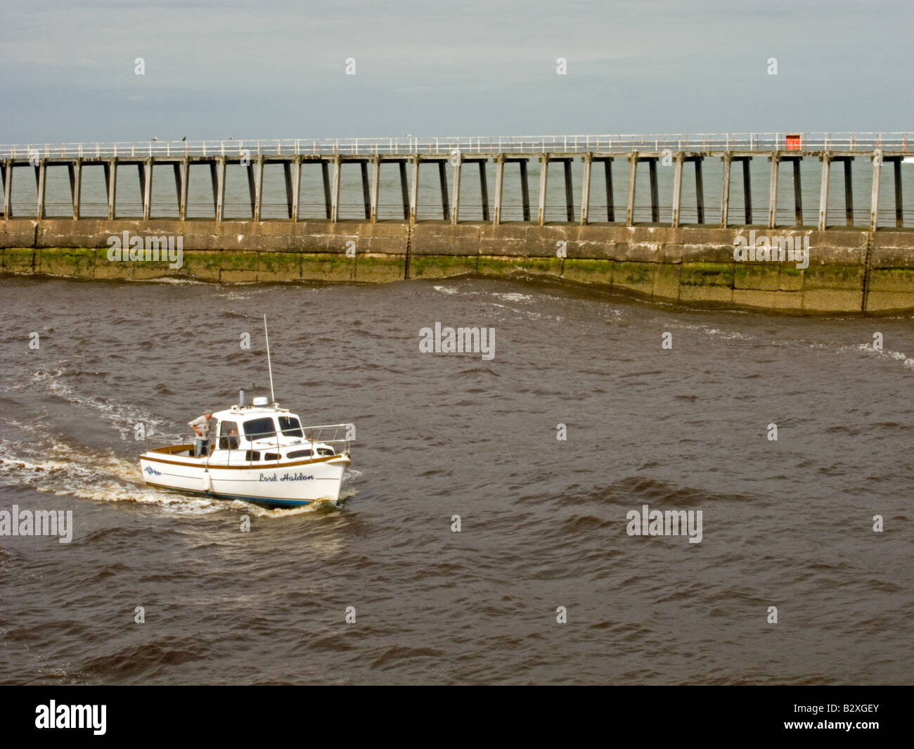 Boat entering Whitby harbour Stock Photo - Alamy