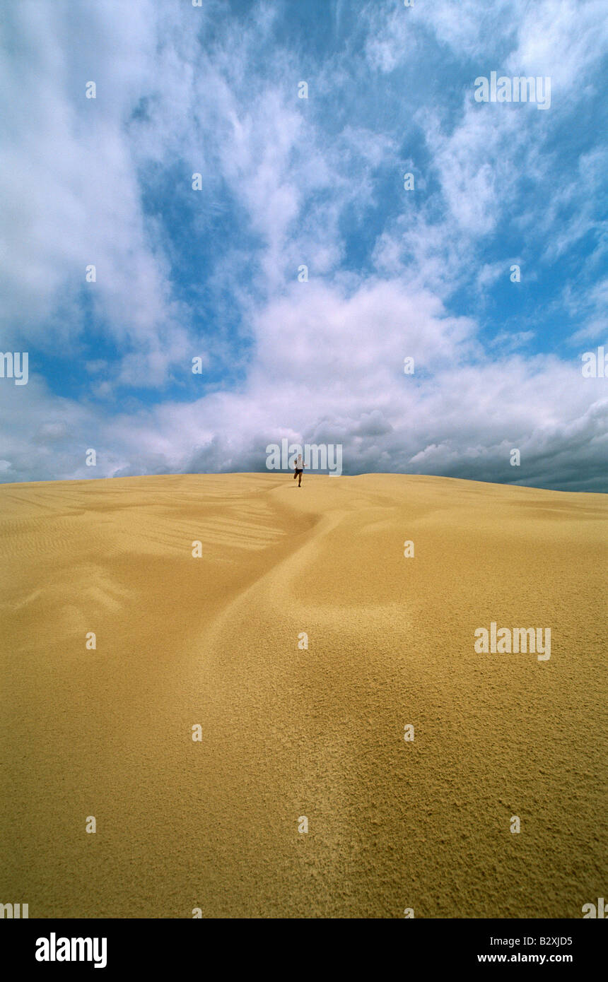 Man outdoors in desert running (far away) Stock Photo