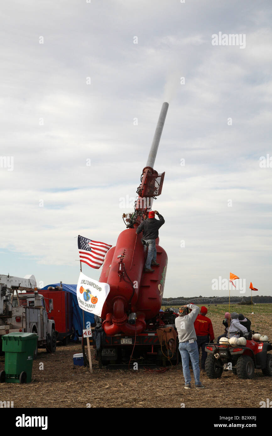 air cannon with man standing on base of gas tanks looking up at