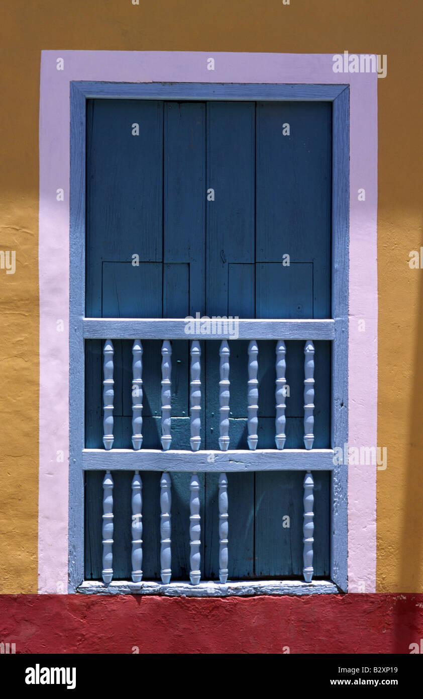 A typical window with wooden shutters and balustrade in Trinidad Cuba
