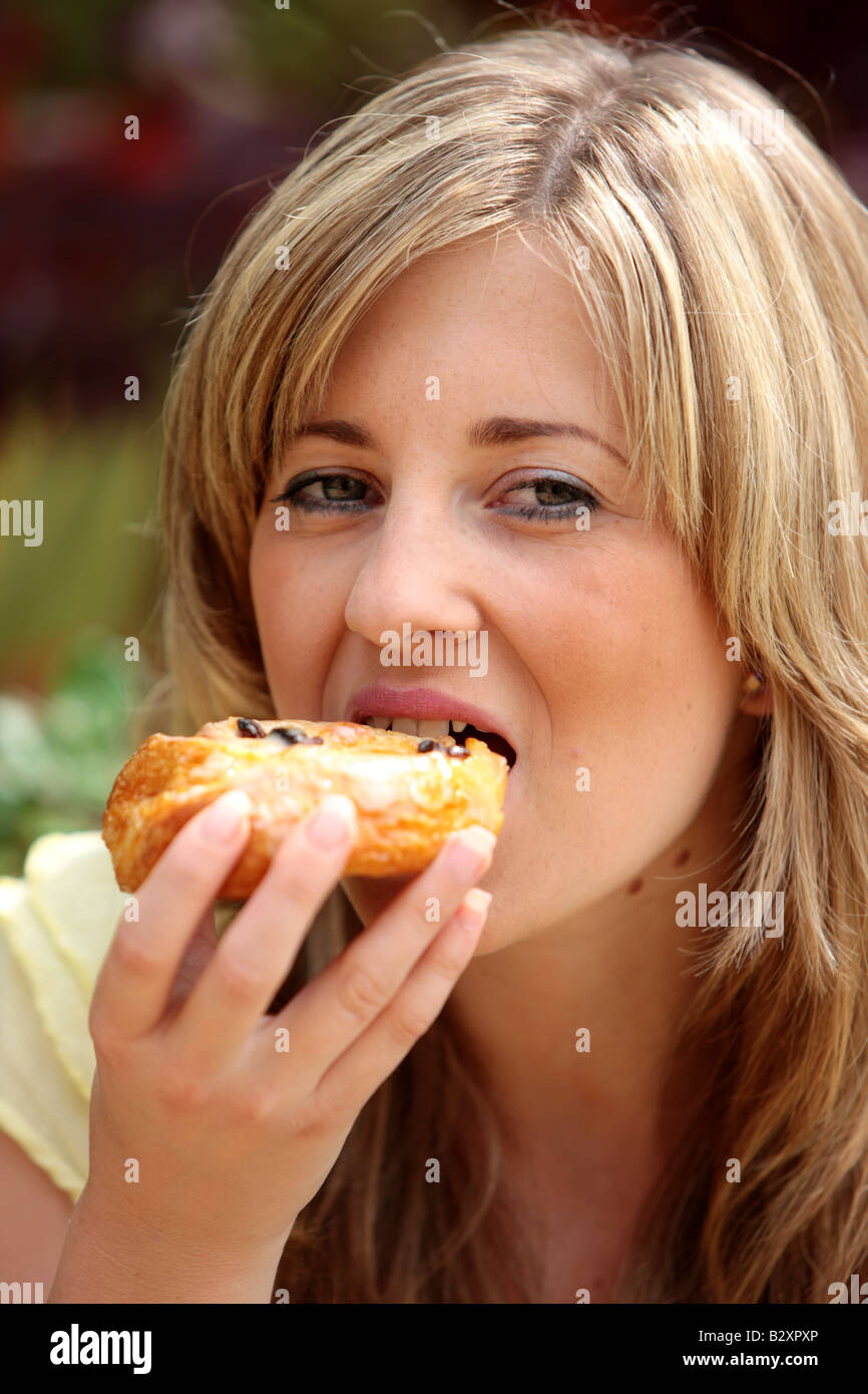 Young Woman Eating Cinnamon Raisin Bun Model Released Stock Photo Alamy