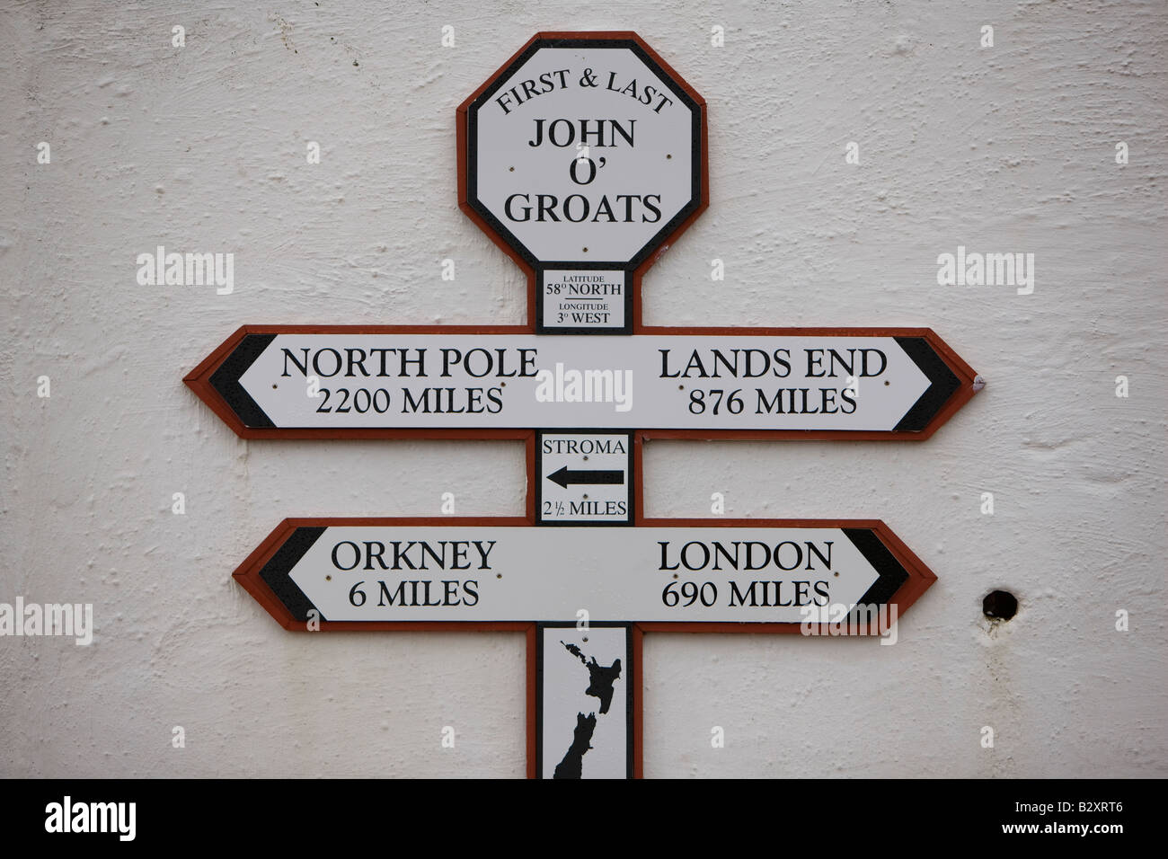 Sign on the wall of a gift shop in John O'Groats, Scotland showing distances to the North Pole, London, Orkney and Land's End Stock Photo