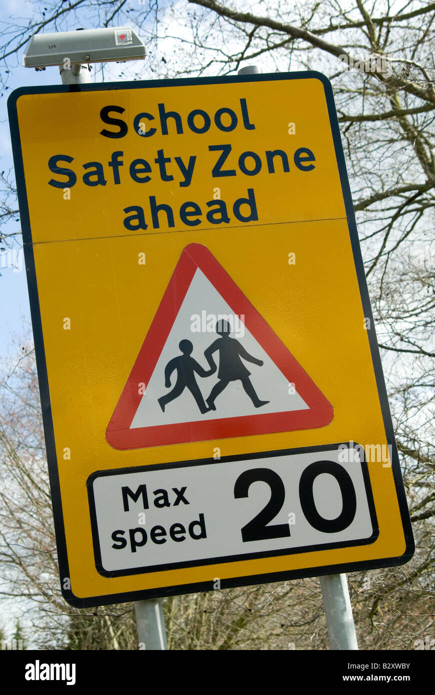 sign warning of school safety zone ahead with a maximum speed limit of 20 miles per hour in the uk Stock Photo