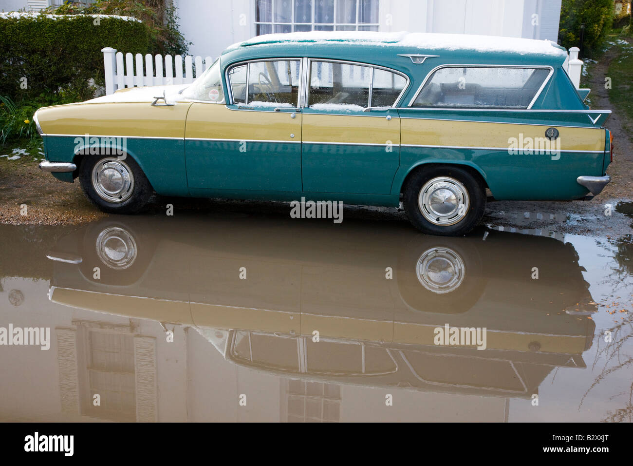 Classic 1950s Vauxhall Cresta estate conversion parked in a puddle outside cottage Stock Photo