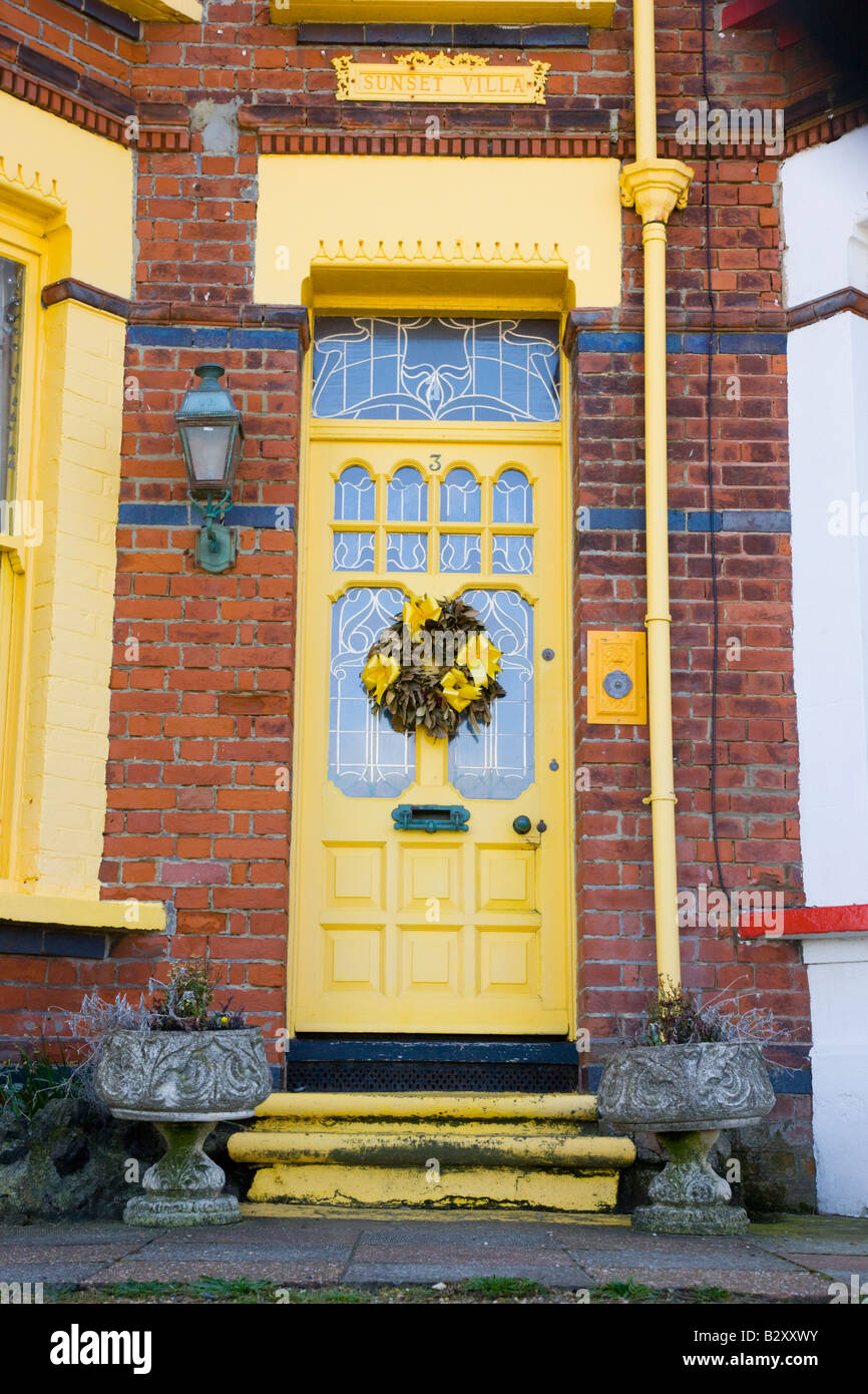 Attractive front door with bright yellow colour scheme Stock Photo