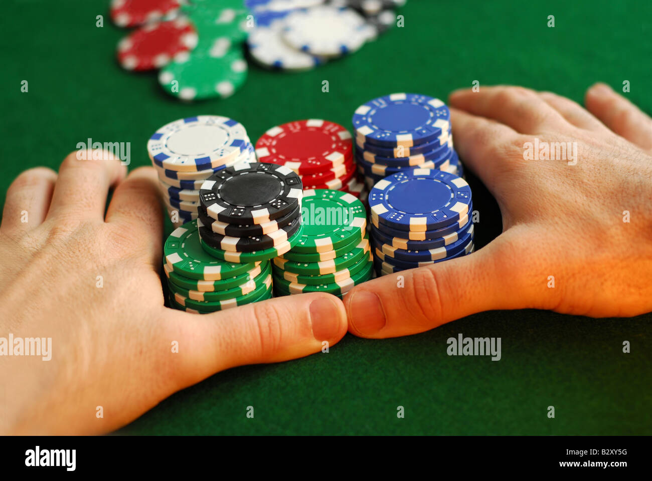 Poker player going all in pushing his chips forward Stock Photo Alamy