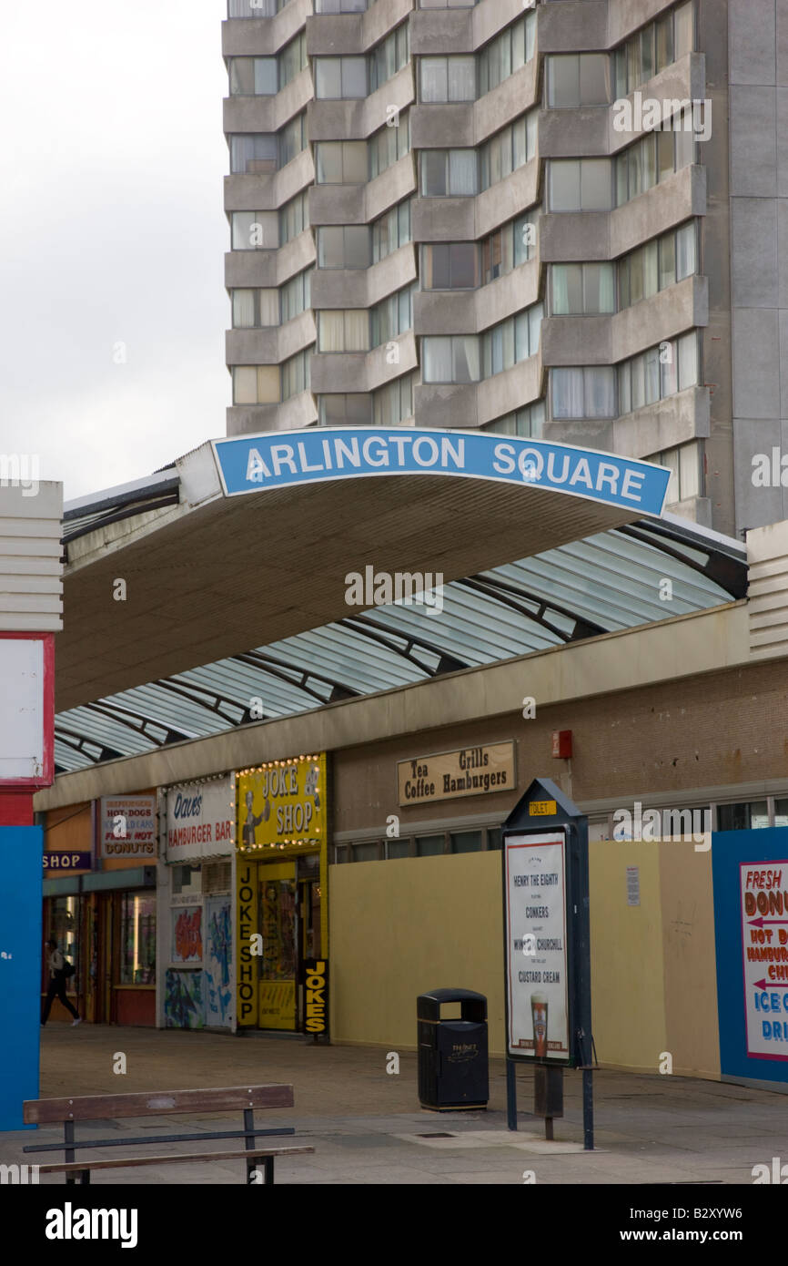 Arcade of shops underneath a tower block of flats in Margate Kent Stock