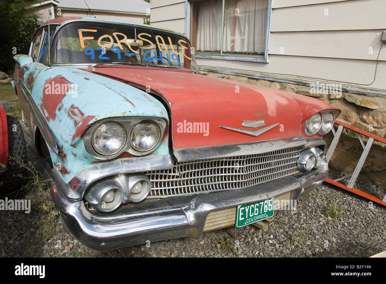 Rusting 1958 Chevrolet with "for sale" sign in Colorado off highway 133