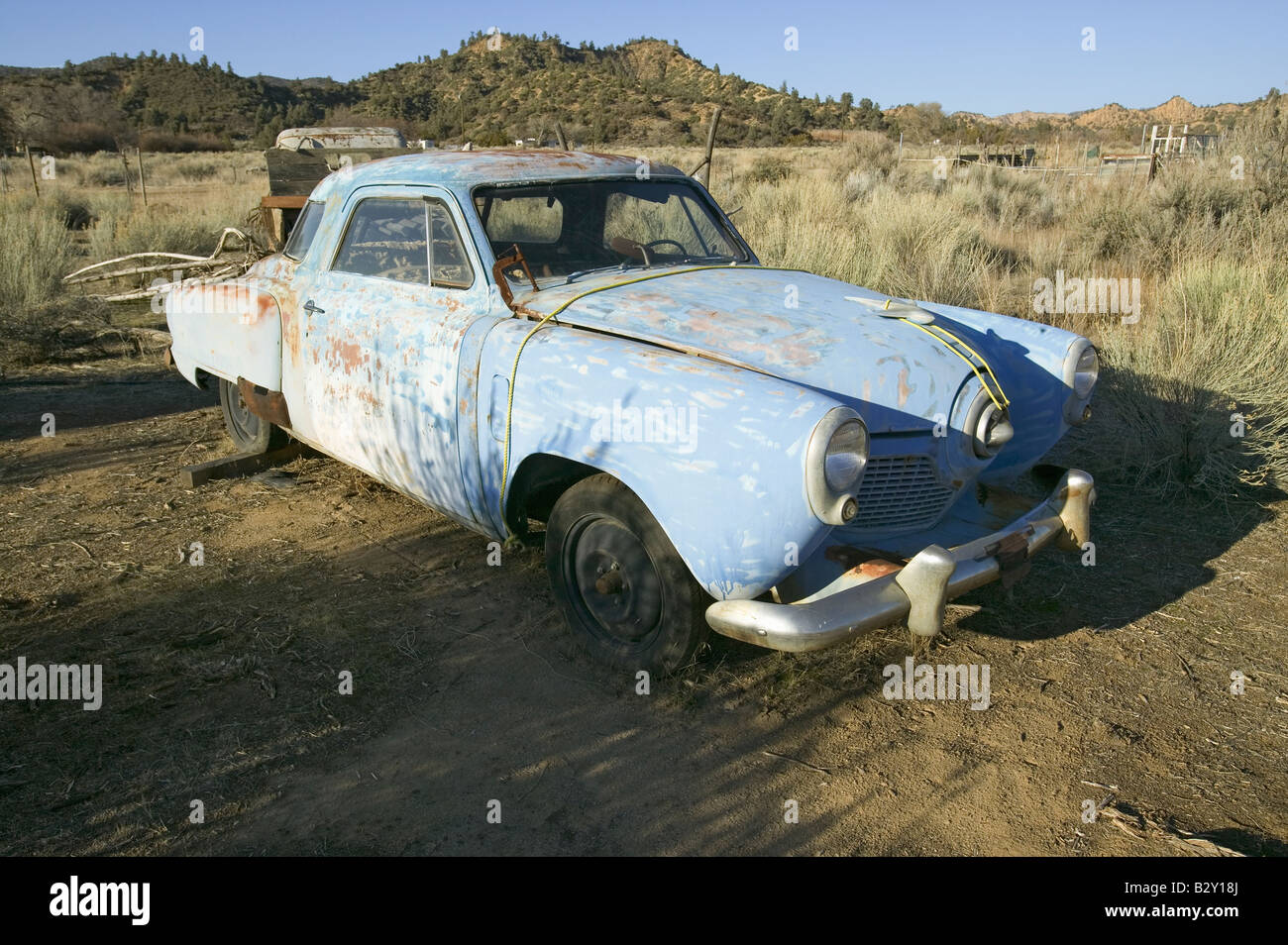Rusted out mid-50's blue Studebaker on side of road, Route 33, near Cuyama, California Stock Photo