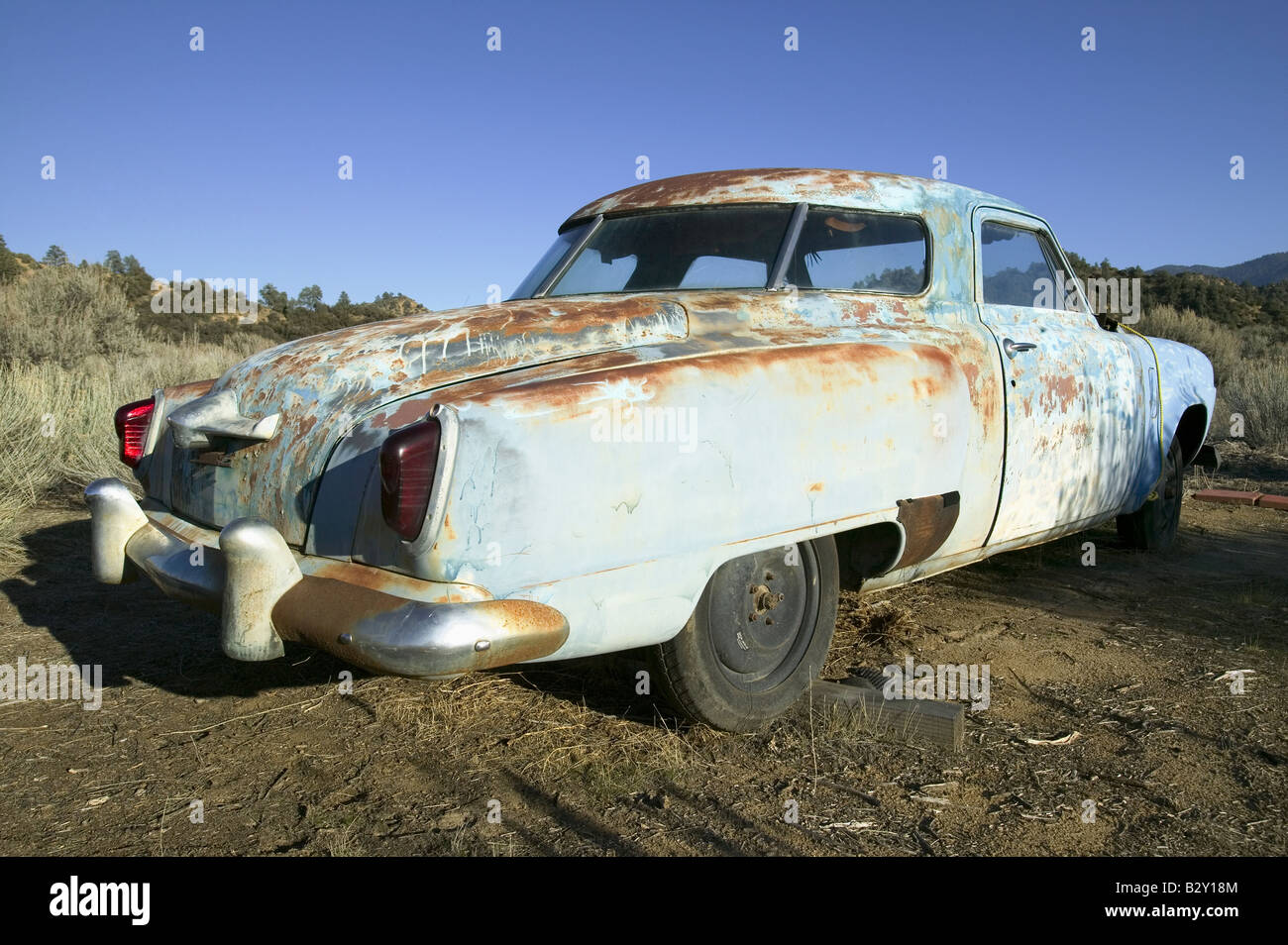 Rusted out mid-50's blue Studebaker on side of road, Route 33, near Cuyama, California Stock Photo