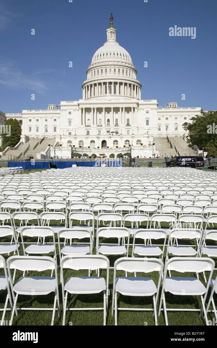 Rows of empty white chairs stand in front of the U.S. Capitol