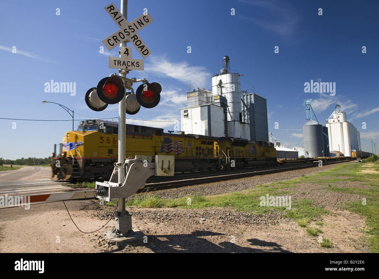 Freight train and blinking crossing light in Big Springs, Nebraska Stock Photo