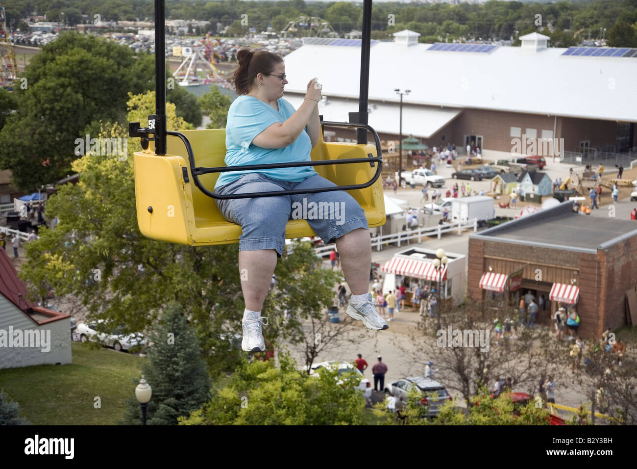 Woman taking picture from chair lift at Iowa State Fair, Des Moines