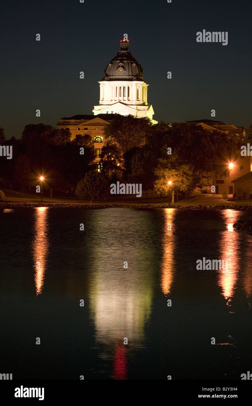 Water with reflection of South Dakota State Capitol and complex at night, Pierre, South Dakota Stock Photo