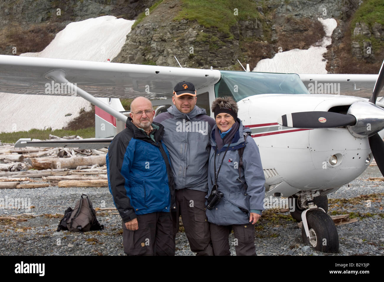 Tourists in front of the small airplane that flew them out to this beach to watch bears in Katmai National Park & Preserve. Stock Photo