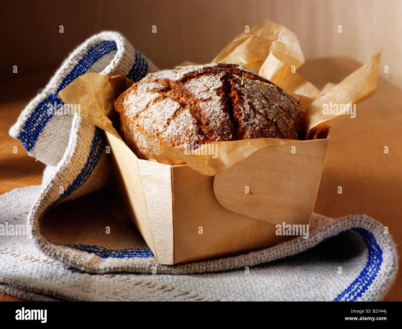 loaf of Artisan Rye bread in a rustic setting on a wood tabl Stock Photo