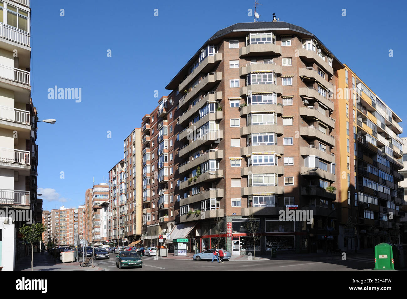 Modern shops high rise multi storey apartment blocks housing and street scene Valladolid Spain Stock Photo
