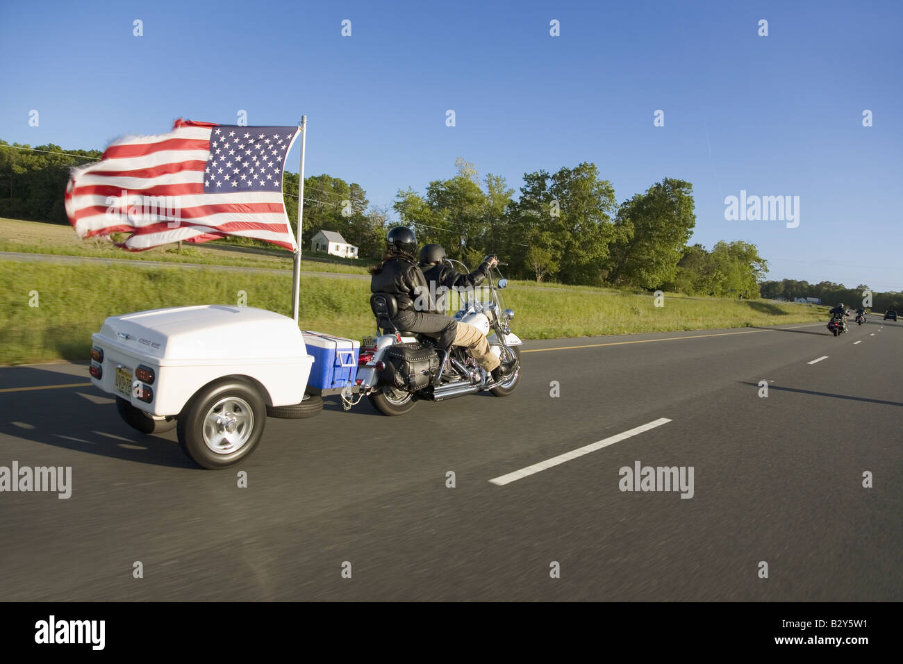 Motorcycle with trailer and US Flag blowing in wind, driving down Route 13  of the Eastern Shore of Maryland Stock Photo - Alamy