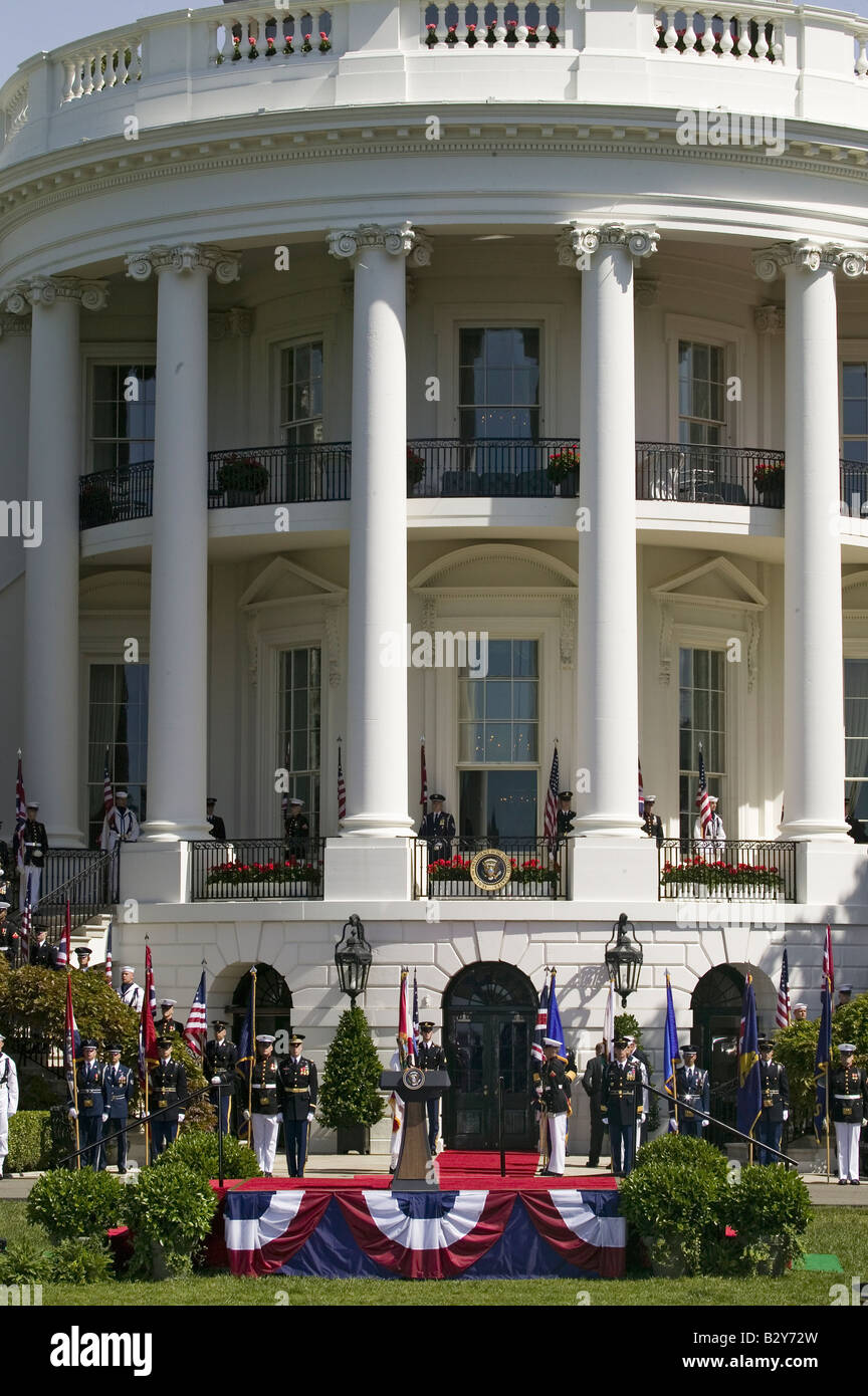 American Flags by military branches in front of the Presidential Seal and Podium on the South Portico of the White House Stock Photo