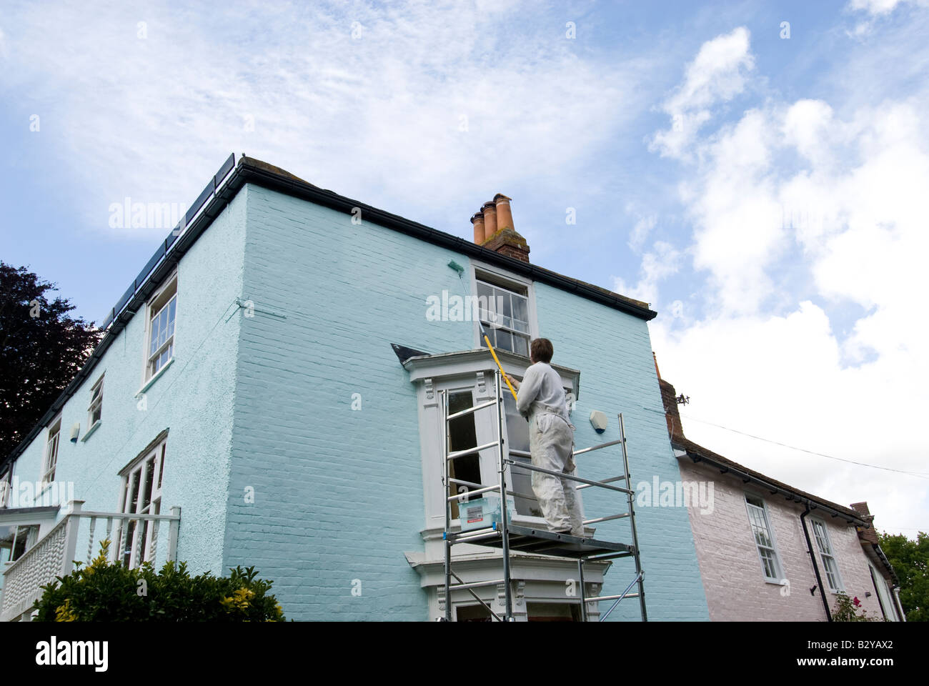Man painting a house Stock Photo Alamy