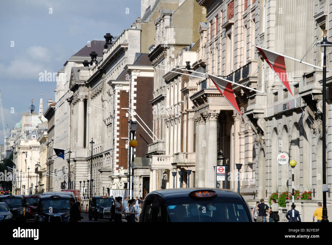 View along Pall Mall with passing black taxi cabs St James s London England Stock Photo