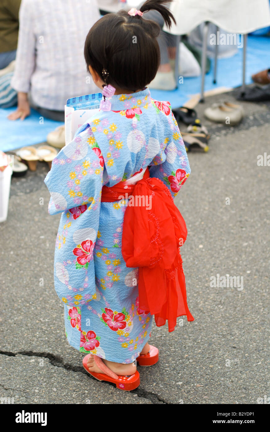 A little girl in a traditional summer kimono or yukata at the neighbourhood  summer Joyama Festival Shimosuwa, Nagano, Japan. Stock Photo