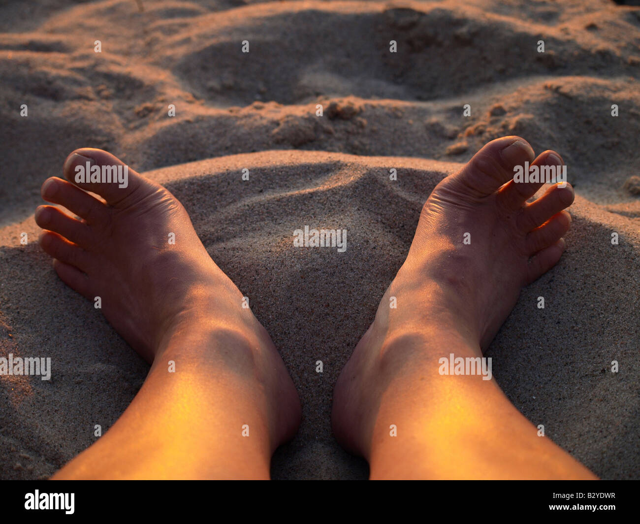 two-feet-in-the-sand-on-the-beach-stock-photo-alamy