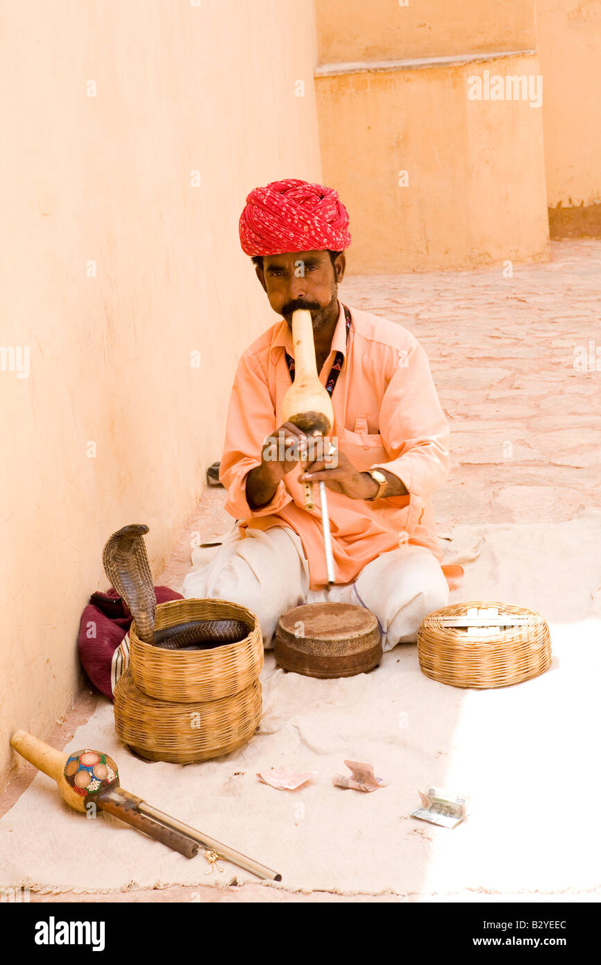 Snake Charmer outside the Red Fort, Jaipur, Rajasthan, performs for tourists. Stock Photo